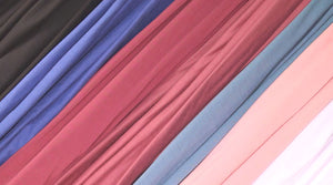 Assorted swatches of DTY brushed fabric in vibrant colors, highlighting the fabric's soft texture and diverse color palette