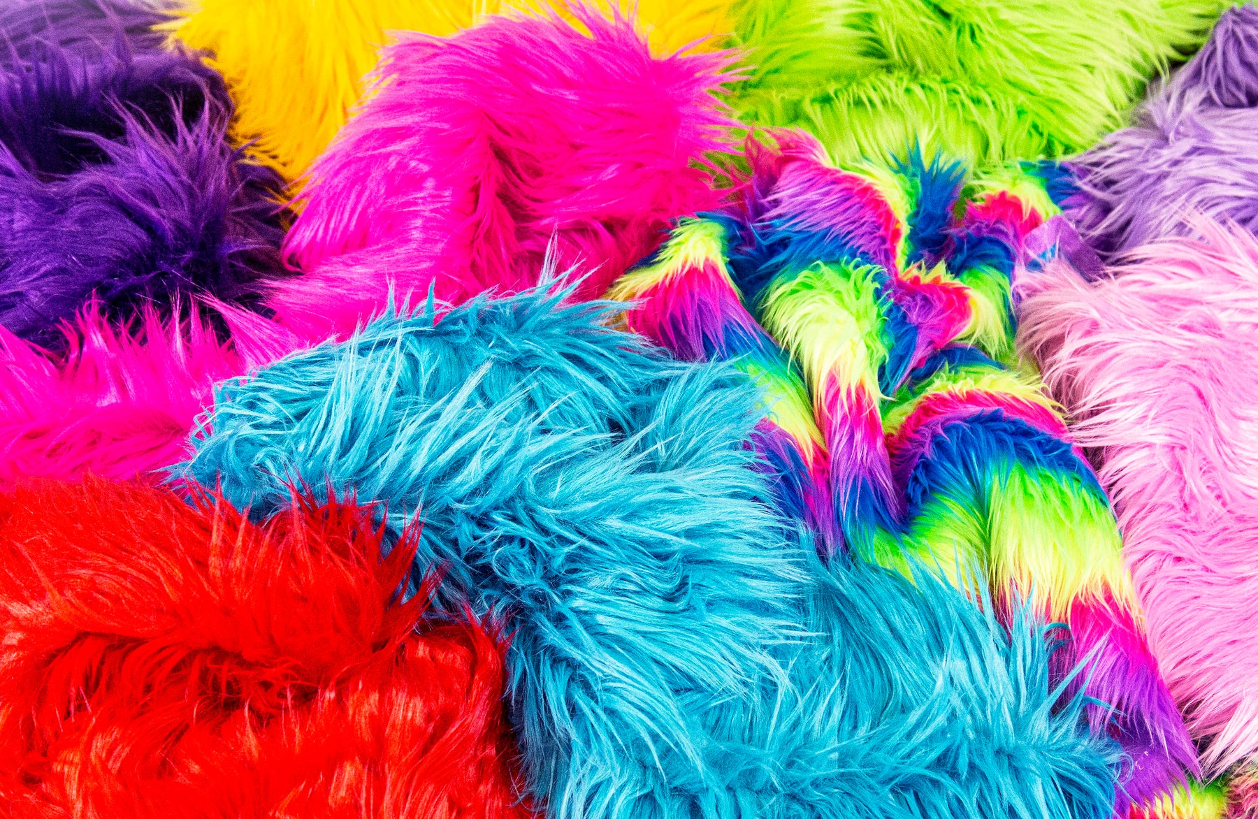 Vibrant array of faux fur fabrics, showcasing a spectrum of colors and the rich, plush texture synonymous with luxury